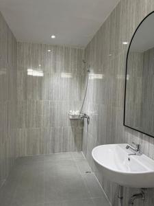 a bathroom with a sink and a mirror at Kuraya Urban Space in Surabaya +11 photos