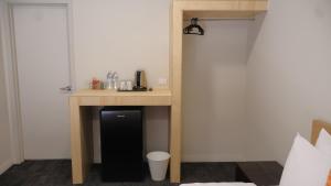a desk in a room with a phone on it at Gallery Boutique Hotel in Fremantle +27 photos