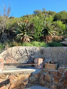 a stone wall with a fire place in a yard at Good Vibes in Uniondale