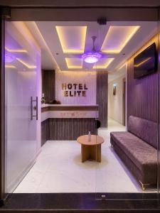 a hotel lobby with a couch and a table at Hotel Elite in Ahmedabad +9 photos