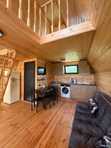 a living room with a couch and a table in a cabin at Cottages in Kobuleti