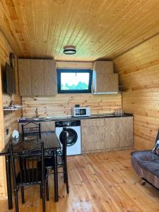 a kitchen and dining room in a log cabin at Cottages in Kobuleti