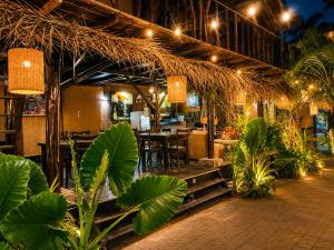 a restaurant with a table and chairs and plants at Coco Palm Villa and Cabanas in Tangalle