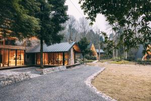 a house with a gravel driveway in front of it at YEYU Hotel in Dujiangyan