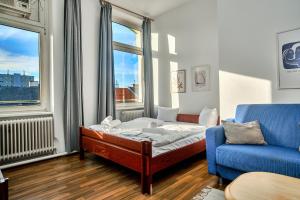 a room with a bed and a couch and a chair at 2 bedrooms & free parking in Vienna