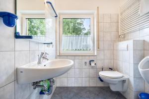 a bathroom with a sink and a toilet at Haus S 42 in Röbel +62 photos