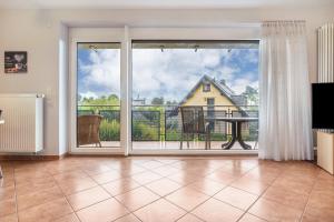 a living room with a large window and a table at Haus S 42 in Röbel