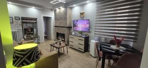 a living room with a television and a dining room at Casa di Clara in Sulmona