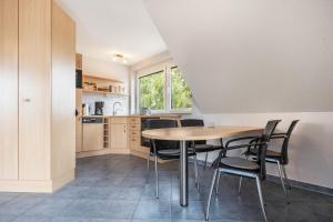 a kitchen and dining room with a table and chairs at Haus S 42 in Röbel