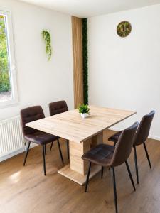 a wooden table and chairs in a room at Haus Martha in Hörbranz +9 photos