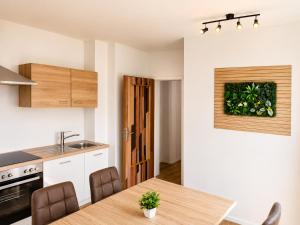 a kitchen with a wooden table in a kitchen at Haus Martha in Hörbranz
