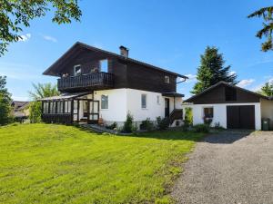 a house with a black roof and a yard at Haus Martha in Hörbranz