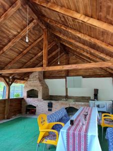 a room with a table and chairs and a pool at Apuseni Escape in Gârda de Sus