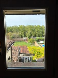 a window with a view of a yard at Casa la Mirage 6 in Bozzolo