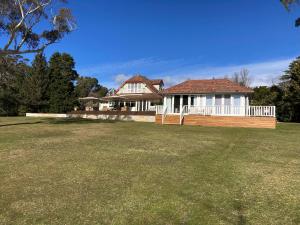 a house with a large yard in front of it at Mount Booralee Estate in Blackheath