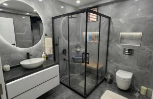 a bathroom with a shower and a sink and a toilet at premium category 2 bedrooms apartment in Lahore