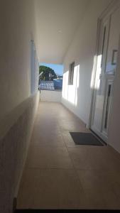an empty hallway of a building with an open door at Beach Paradise Apartments in San Andrés
