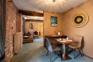 a dining room with a table and chairs and a brick wall at Hotel Schinvelder Hoeve in Schinveld