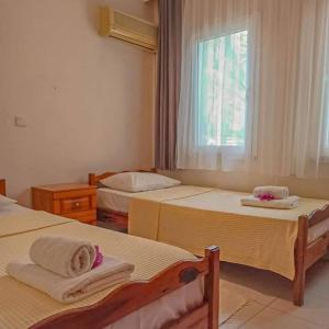 a bedroom with two beds and a window at Garden-view suite room in Ortaca +82 photos