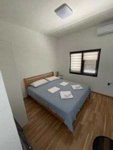 a bedroom with a bed with two towels on it at Anita room in Kotor +12 photos