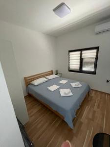 a bedroom with a bed with two towels on it at Anita room in Kotor