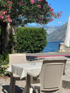 a table and chairs with a view of a lake at Anita room in Kotor