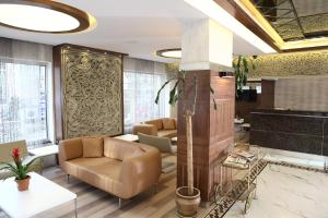 a lobby with a couch and chairs in a building at Sultan Hotel-Restaurant-Bistro in Sivas