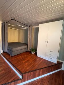 a bedroom with a bed and a cabinet in a room at Sweet home in Kristiansund
