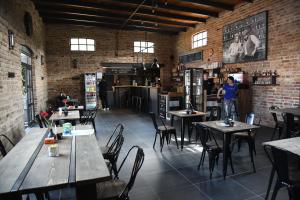 a restaurant with tables and chairs and a person standing in a room at Fun & Relax Park Thurnau in Thurnau