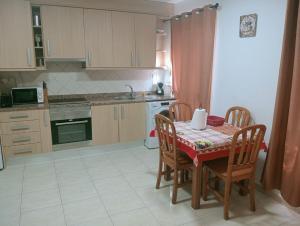 a kitchen with a table and chairs and a kitchen with a table and a kitchen at paraiso soleado in Tazacorte
