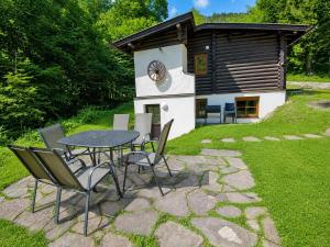 a table and chairs in front of a cabin at Chalet in Wörgl near Ski Lift in Hopfgarten im Brixental