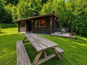a wooden picnic table in front of a cabin at Rustic chalet near SkiWelt Wilder Kaiser in Salvenberg