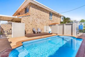 a swimming pool in front of a brick building at 1-41 Park Street in Evans Head