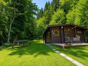 a log cabin with a picnic table and a bench at Rustic chalet near SkiWelt Wilder Kaiser in Salvenberg +30 photos