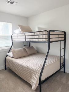 a bedroom with two bunk beds in a room at Remodeled 4BR 2BA Steps from Georgetown Square in Georgetown