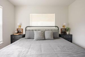 a bedroom with a bed with two dressers and a window at Remodeled 4BR 2BA Steps from Georgetown Square in Georgetown