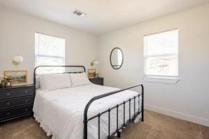 a bedroom with a bed and a mirror at Remodeled 4BR 2BA Steps from Georgetown Square in Georgetown +63 photos