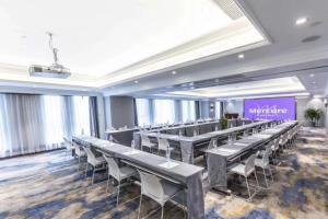 a large room with rows of tables and chairs at Mercure Xian North in Xi'an