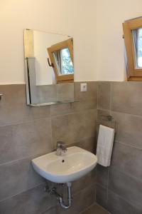 a bathroom with a sink and a mirror at Bungalov B in Sveti Filip i Jakov