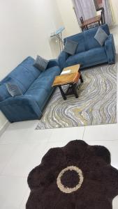 a blue couch in a living room with a coffee table at هدى صلالة in Salalah