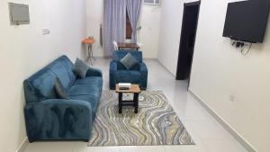a living room with a couch and two chairs and a table at هدى صلالة in Salalah