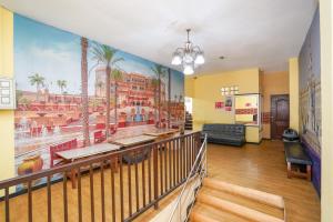 a lobby with a mural of a hotel at RedDoorz at Gangnam Hotel near Mall Olympic Garden in Betek