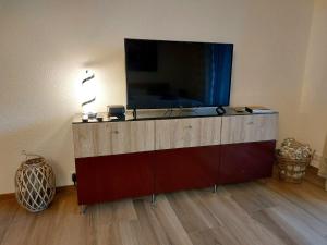 a large flat screen tv on top of a cabinet at Ferienglück Unterkirnach in Unterkirnach +21 photos