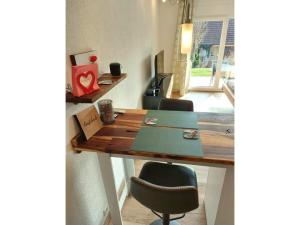 a wooden table with two chairs and a desk at Ferienglück Unterkirnach in Unterkirnach