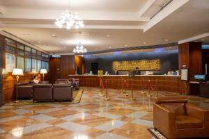a lobby of a hotel with chairs and a bar at Metropark Hotel Kowloon Hong Kong in Hong Kong