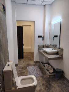 a bathroom with a toilet and a sink at Dothalu Villa in Ahangama