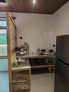 a small kitchen with a sink and a refrigerator at Dothalu Villa in Ahangama +17 photos