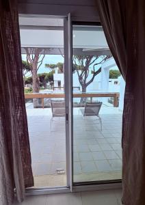 a sliding glass door with a view of a patio at Villa Pinares de Roche - Piscina privada - Playa a 6 min in Roche
