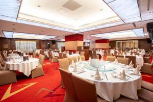 a banquet hall with white tables and chairs at Metropark Hotel Kowloon Hong Kong in Hong Kong