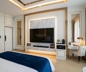 a bedroom with a large tv and a large bed at Kalasin Residence Hotel in Ban Bin Tong